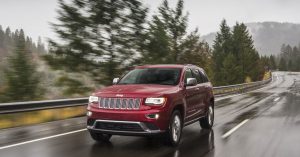 The 2019 Jeep Grand Cherokee driving on a rainy highway